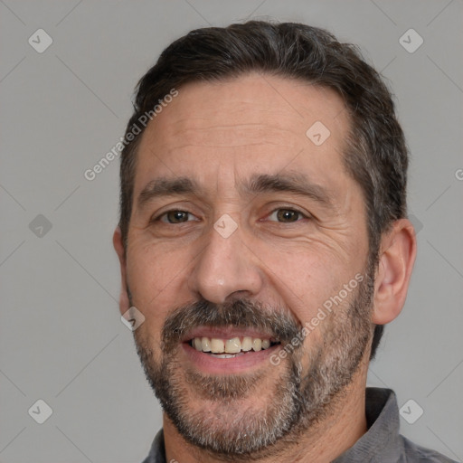 Joyful white adult male with short  black hair and brown eyes