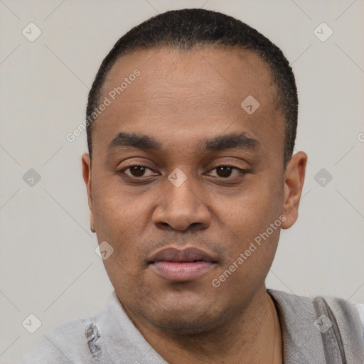 Joyful black young-adult male with short  black hair and brown eyes
