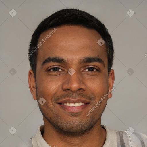 Joyful black young-adult male with short  black hair and brown eyes