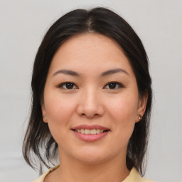 Joyful asian young-adult female with medium  brown hair and brown eyes