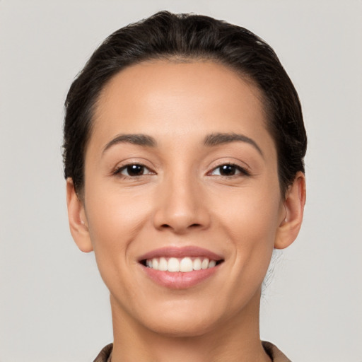 Joyful white young-adult female with short  brown hair and brown eyes