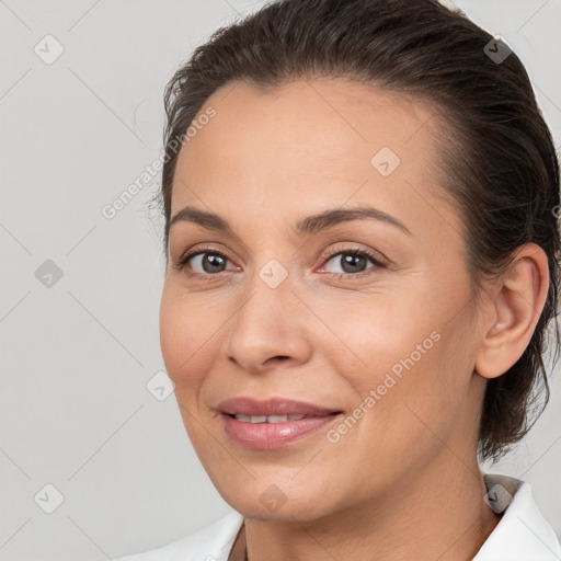 Joyful white adult female with medium  brown hair and brown eyes