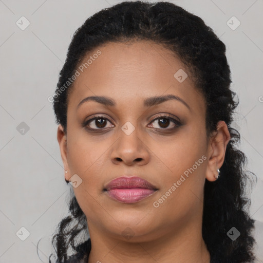 Joyful black young-adult female with long  brown hair and brown eyes