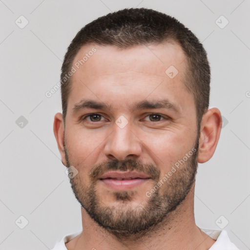 Joyful white young-adult male with short  brown hair and brown eyes