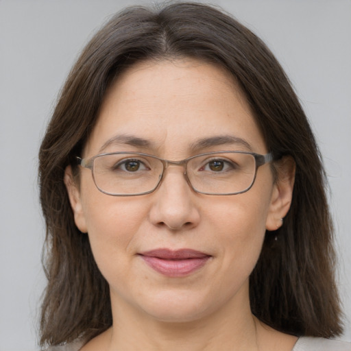 Joyful white adult female with medium  brown hair and grey eyes