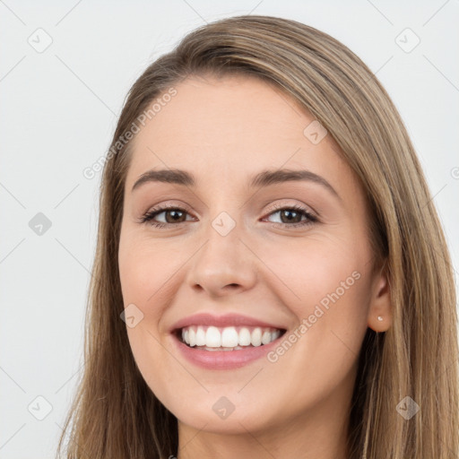 Joyful white young-adult female with long  brown hair and brown eyes