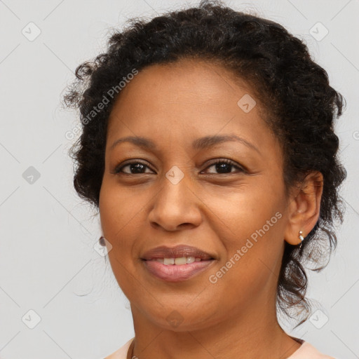 Joyful black adult female with medium  brown hair and brown eyes