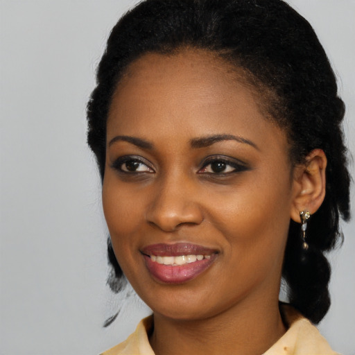 Joyful black young-adult female with medium  black hair and brown eyes