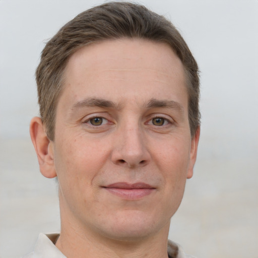 Joyful white adult male with short  brown hair and grey eyes