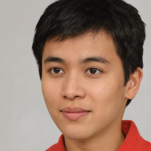Joyful asian young-adult male with short  brown hair and brown eyes