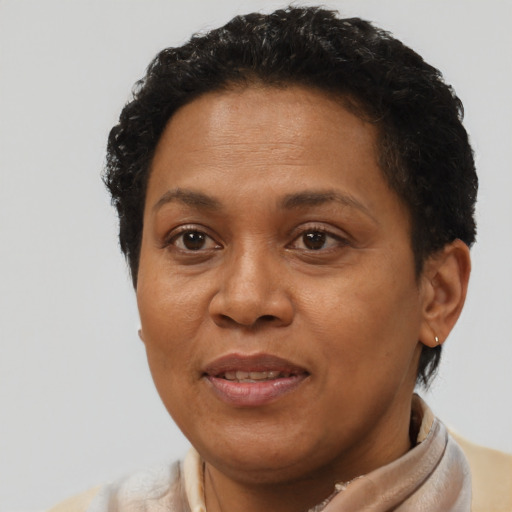Joyful black adult female with short  brown hair and brown eyes
