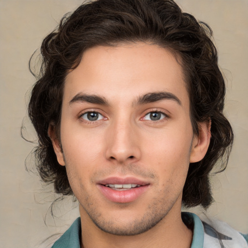 Joyful white young-adult male with medium  brown hair and brown eyes