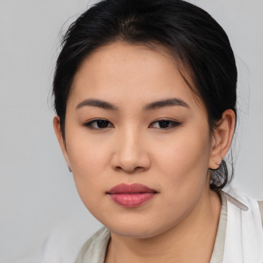 Joyful asian young-adult female with medium  brown hair and brown eyes