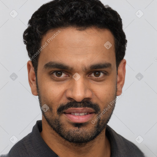 Joyful black young-adult male with short  black hair and brown eyes