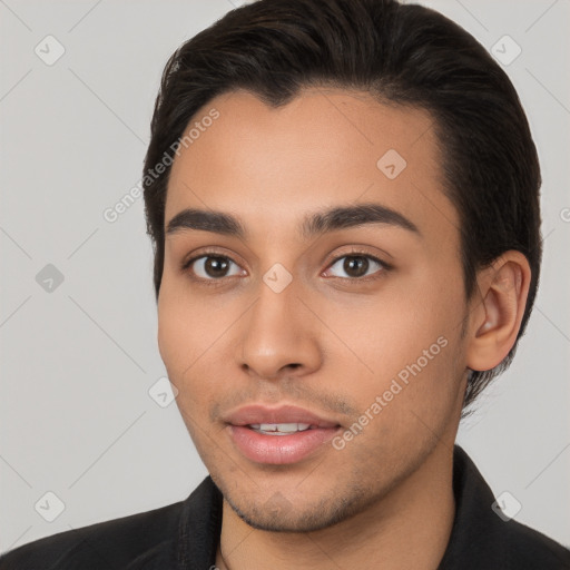 Joyful white young-adult male with short  black hair and brown eyes