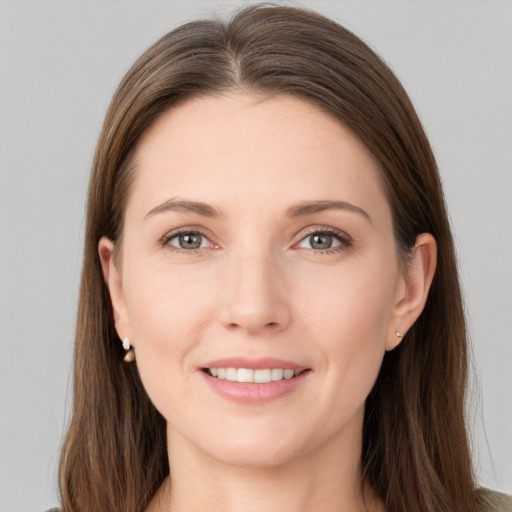 Joyful white young-adult female with long  brown hair and grey eyes