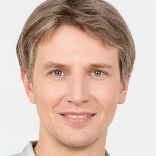 Joyful white adult male with short  brown hair and grey eyes