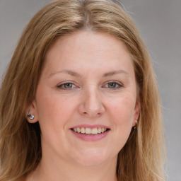 Joyful white young-adult female with long  brown hair and blue eyes