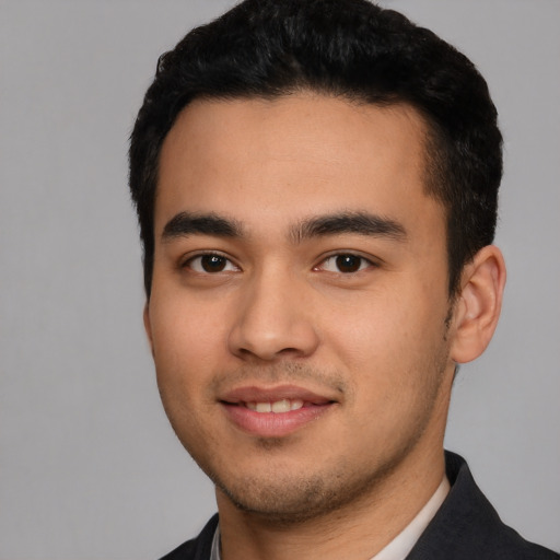 Joyful latino young-adult male with short  black hair and brown eyes