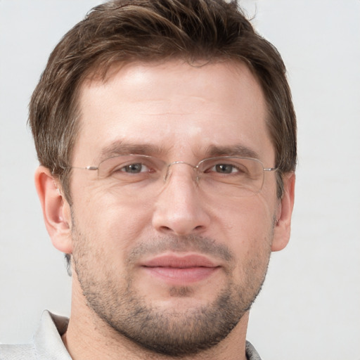 Joyful white adult male with short  brown hair and grey eyes