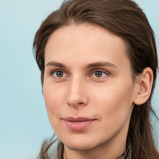 Joyful white young-adult female with long  brown hair and grey eyes