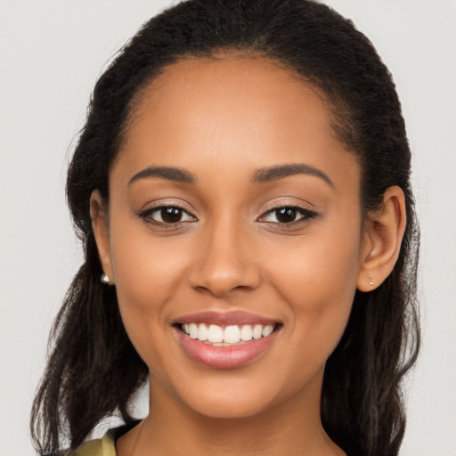 Joyful latino young-adult female with long  brown hair and brown eyes