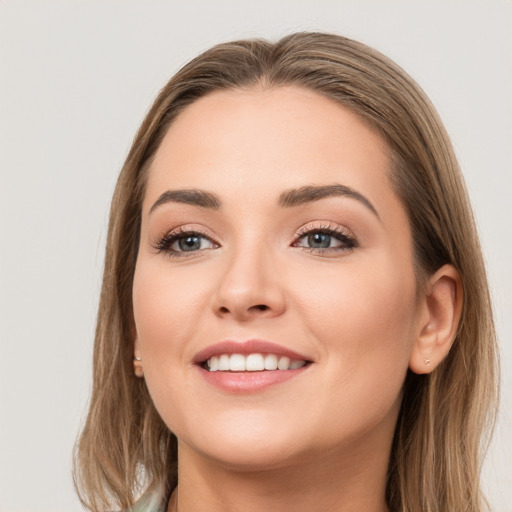 Joyful white young-adult female with long  brown hair and grey eyes