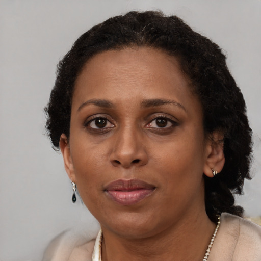 Neutral black adult female with short  brown hair and brown eyes