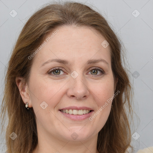 Joyful white adult female with long  brown hair and green eyes