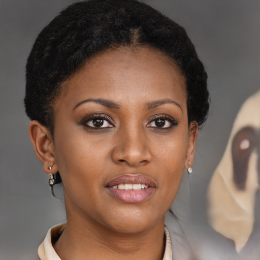 Joyful black young-adult female with short  brown hair and brown eyes