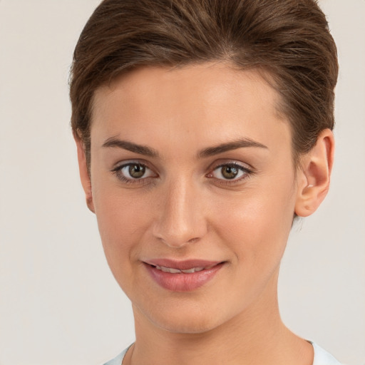 Joyful white young-adult female with short  brown hair and brown eyes