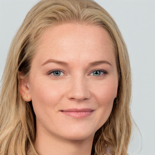 Joyful white young-adult female with long  brown hair and blue eyes