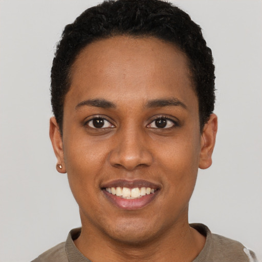 Joyful black young-adult female with short  black hair and brown eyes