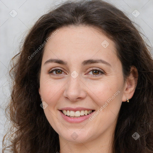 Joyful white adult female with long  brown hair and brown eyes