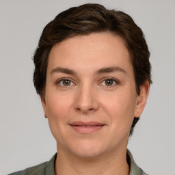 Joyful white young-adult female with short  brown hair and grey eyes