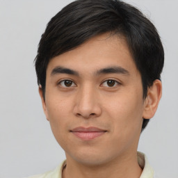 Joyful latino young-adult male with short  brown hair and brown eyes