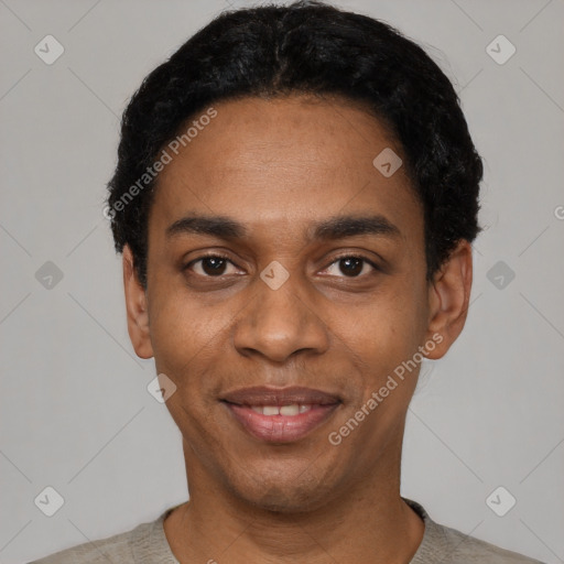 Joyful black young-adult male with short  black hair and brown eyes