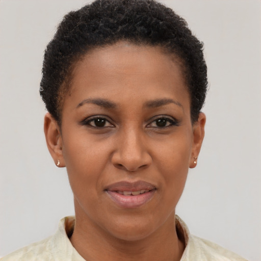 Joyful black young-adult female with short  brown hair and brown eyes