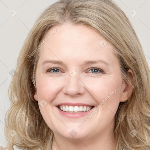 Joyful white young-adult female with long  brown hair and blue eyes