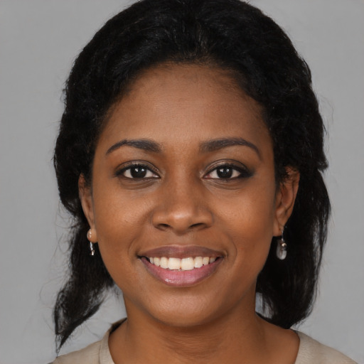 Joyful black young-adult female with medium  black hair and brown eyes