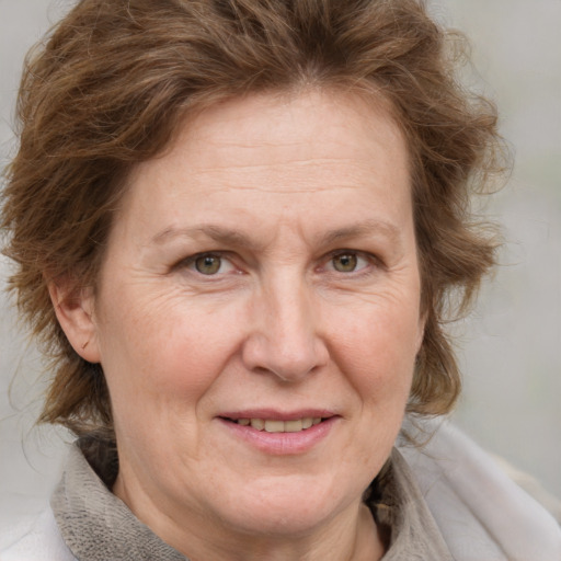 Joyful white middle-aged female with medium  brown hair and blue eyes