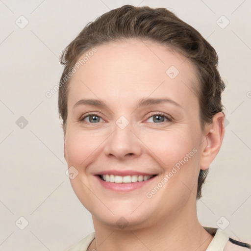 Joyful white young-adult female with short  brown hair and grey eyes