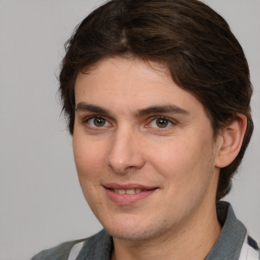 Joyful white young-adult male with medium  brown hair and brown eyes