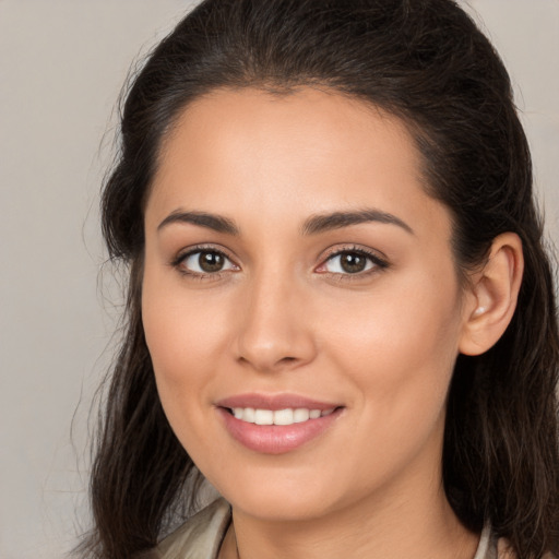 Joyful white young-adult female with medium  brown hair and brown eyes