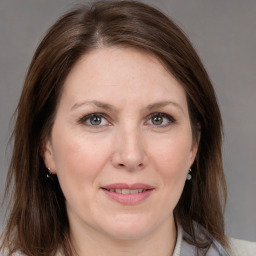 Joyful white adult female with medium  brown hair and grey eyes