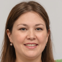 Joyful white adult female with long  brown hair and grey eyes