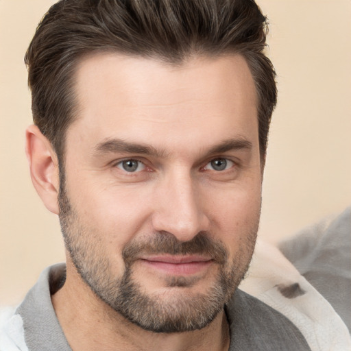 Joyful white adult male with short  brown hair and brown eyes