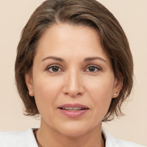 Joyful white young-adult female with medium  brown hair and brown eyes