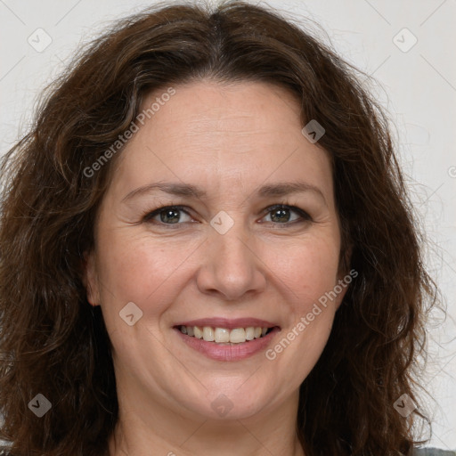 Joyful white adult female with long  brown hair and brown eyes