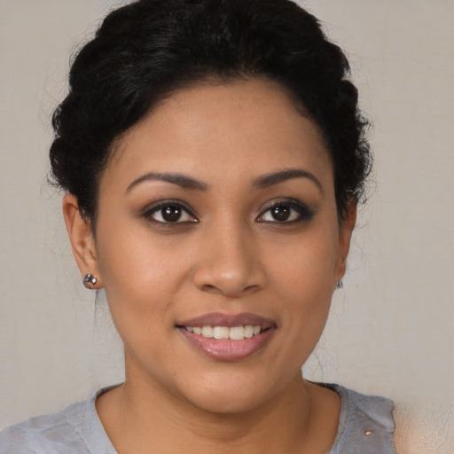 Joyful latino young-adult female with short  brown hair and brown eyes